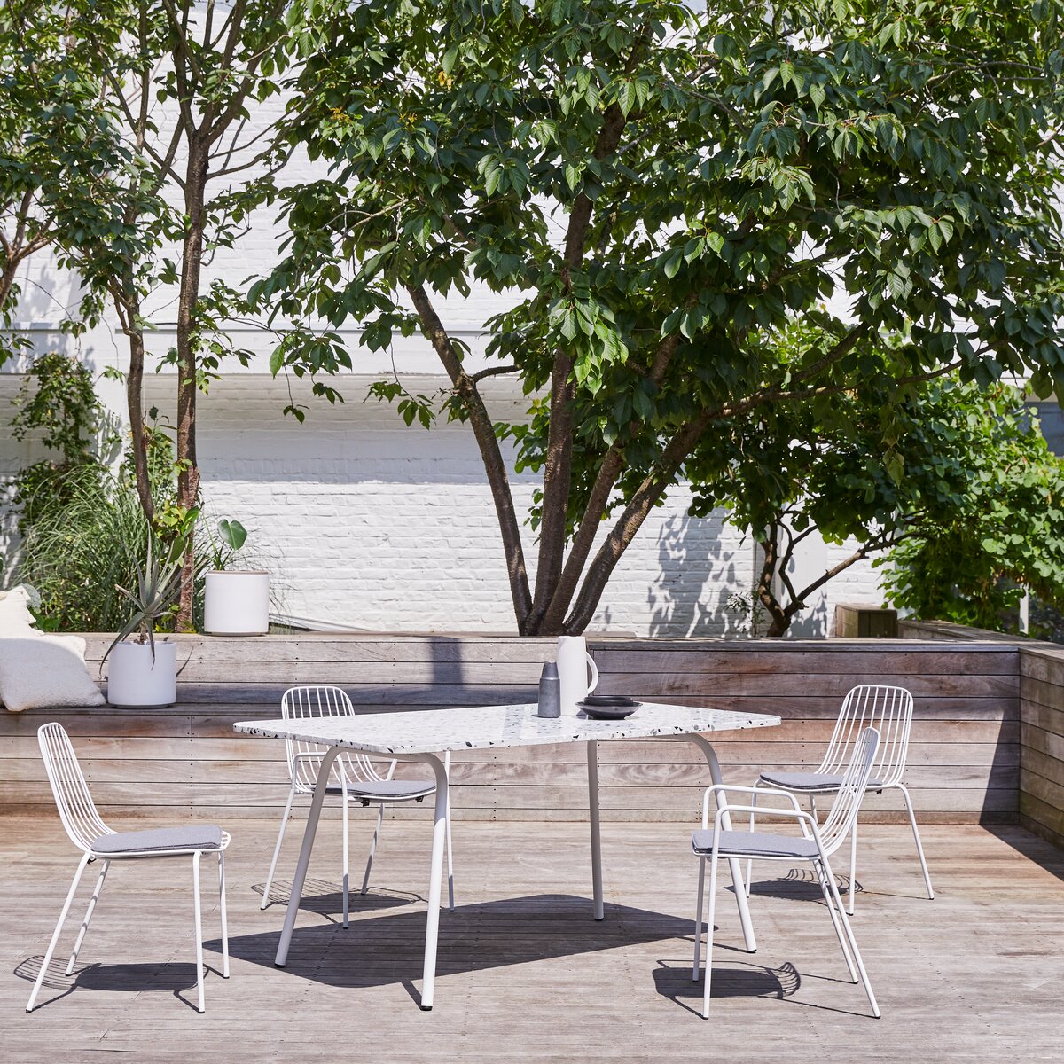 White metal outdoor store table and chairs